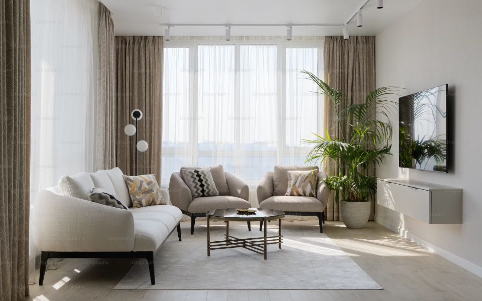 Living de una casa familiar con sofá y ventanal, ambiente tratado por SEDEL